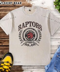 Retro washed t-shirt featuring the Toronto Raptors NBA logo framed by a laurel wreath, perfect for basketball fans.