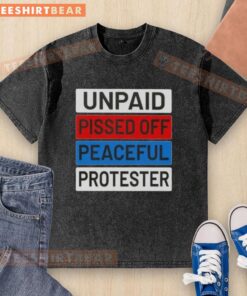 Alt Text: Peaceful protester wearing a washed T-shirt displaying 'Nice Unpaid Pissed Off' message at a demonstration.
