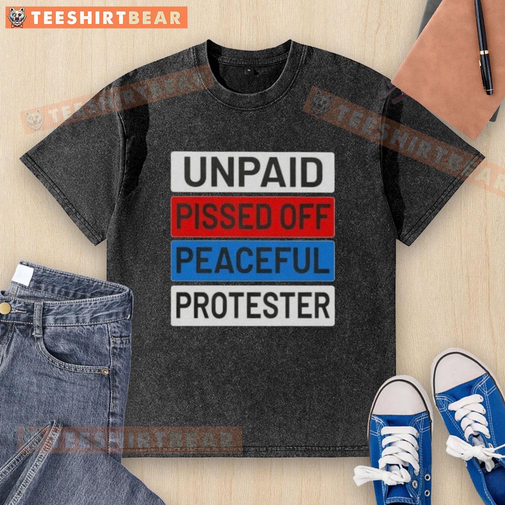 nice-unpaid-pissed-off-peaceful-protester-washed-t-shirt Alt Text: Peaceful protester wearing a washed T-shirt displaying 'Nice Unpaid Pissed Off' message at a demonstration.