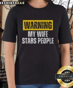 Alt Text: Vintage ladies tee featuring a humorous warning: My wife stabs people for a fun, edgy fashion statement.