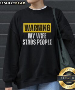 Vintage sweatshirt with 'Warning: My Wife Stabs People' text, perfect for humor lovers and unique fashion enthusiasts.