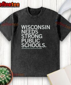 Nice Wisconsin Needs Strong Public Schools washed t-shirt displayed on a rustic wooden background.