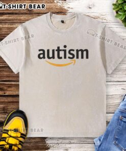 Official Autism X Amazon parody logo on a washed t-shirt, featuring a playful design for autism awareness merchandise.