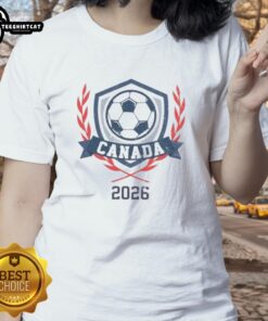Alt Text: Vintage Canada 2026 soccer crest on a ladies tee, showcasing official design and vibrant colors for soccer fans.