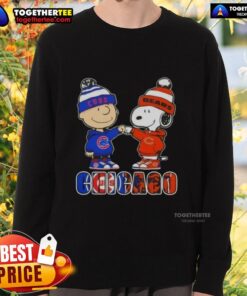 Official Charlie Brown fist bump with Snoopy on Chicago City Sports Cubs X Bears sweatshirt, perfect for fans.