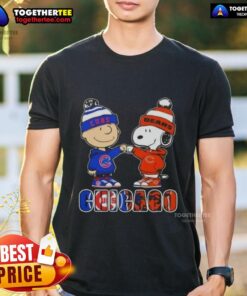 Official Charlie Brown fist bump with Snoopy on Chicago Cubs and Bears T-shirt, perfect for sports fans.