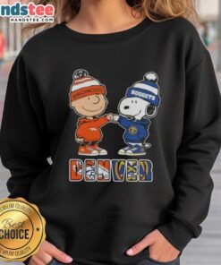 Official Charlie Brown fist bump with Snoopy on Denver City Sports Broncos X Nuggets sweatshirt, perfect for fans.