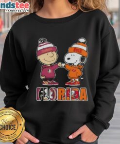 Official Charlie Brown fist bump sweatshirt featuring Snoopy, perfect for Florida City sports fans and Seminoles/Buccaneers supporters.