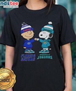 Official Charlie Brown fist bump with Snoopy on a Florida Gators x Jacksonville Jaguars ladies tee design.