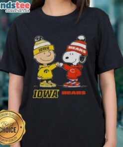 Official Charlie Brown fist bump with Snoopy on Iowa Hawks x Chicago Bears ladies tee, perfect for fans and casual wear.