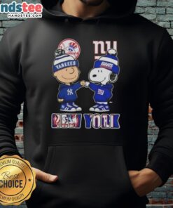 Alt Text: Official Charlie Brown fist bump with Snoopy in New York City sports hoodie featuring Yankees and Giants skyline.