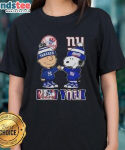 Official Charlie Brown fist bump with Snoopy in New York City skyline, featuring Yankees and Giants. Ladies tee design.