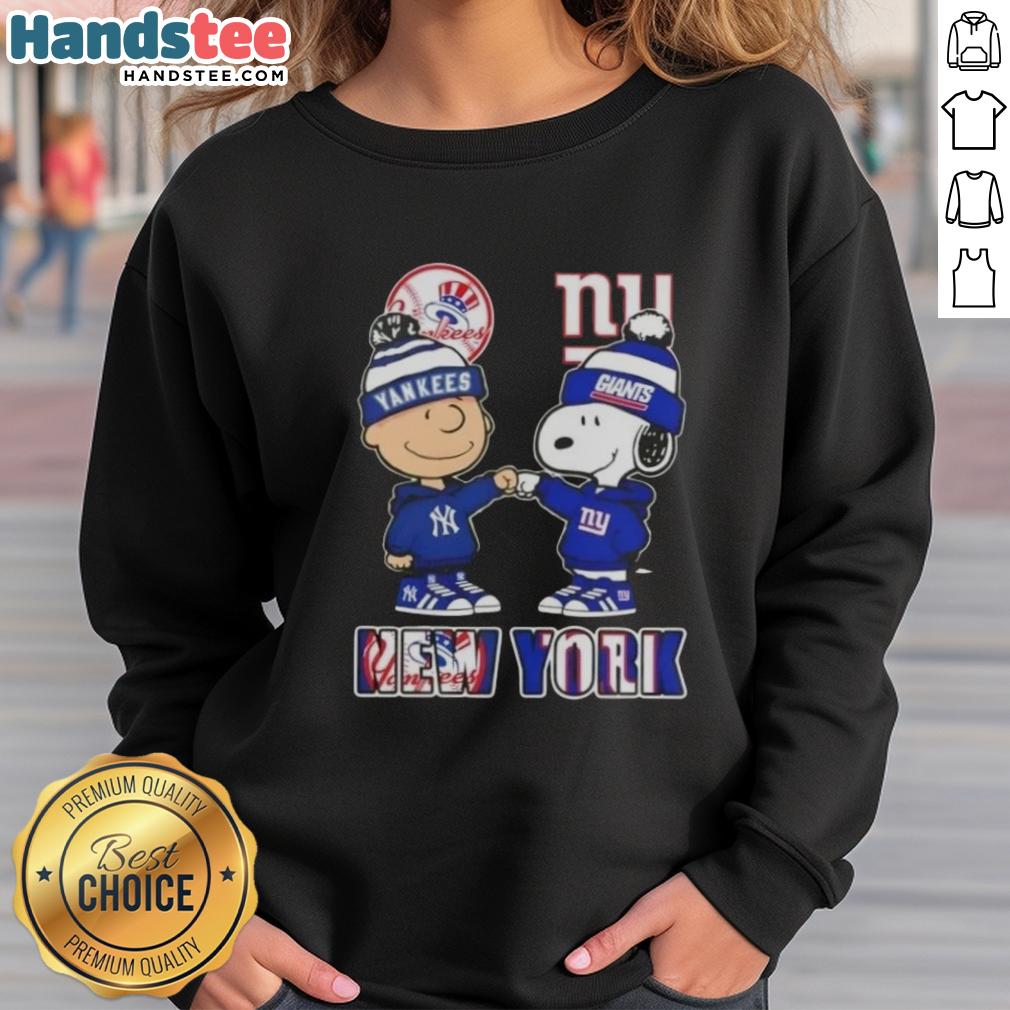 official-charlie-brown-fist-bump-snoopy-new-york-city-sports-yankees-x-giants-skyline-sweatshirt Official Charlie Brown fist bump with Snoopy on NYC skyline sweatshirt, featuring Yankees and Giants sports themes.