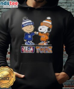 Alt Text: Official Charlie Brown fist bump with Snoopy on a New York City sports hoodie featuring Yankees and Knicks logos.
