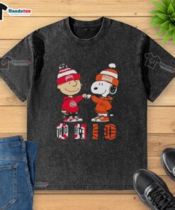 Official Charlie Brown fist bump with Snoopy on Ohio City sports Buckeyes X Cleveland Browns washed t-shirt design.