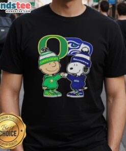 Alt Text: Official Charlie Brown fist bump Snoopy graphic on Oregon Ducks X Seattle Seahawks T-shirt for fans.