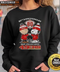 Alt Text: Official Charlie Brown x Snoopy 80th Anniversary sweatshirt featuring San Francisco 49ers skyline design, 1946-2026.