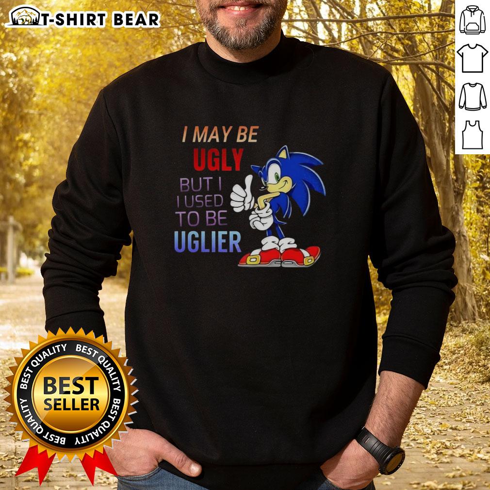 Official I May Be Ugly But I Used To Be Uglier Cartoon Hedgehog Sweatshirt Cartoon hedgehog sweatshirt featuring the phrase 'I May Be Ugly But I Used To Be Uglier' in a playful design.