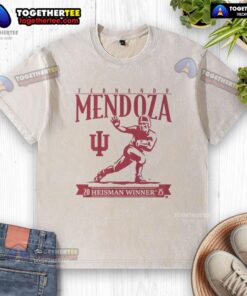 Official Indiana Football Fernando Mendoza Heisman Trophy washed t-shirt featuring logo and player graphics.