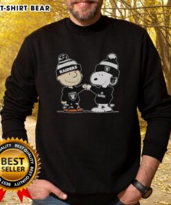 Alt Text: Official Los Angeles Raiders Snoopy and Charlie Brown Best Friends Sweatshirt featuring iconic characters in team colors.