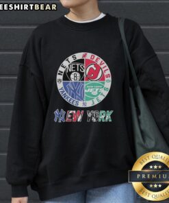Alt Text: Official New York Nets, Devils, Mets, Jets mashup logo sweatshirt showcasing NYC sports team pride.