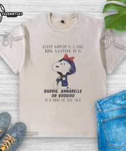 Official Peanuts Every Woman Is A Doll T-Shirt featuring Barbie, Annabelle, and Voodoo designs on a dice-washed fabric.
