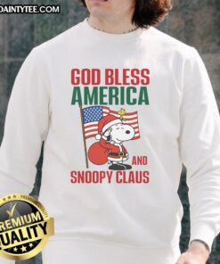 Alt Text: Official Peanuts God Bless America and Snoopy Claus Sweatshirt featuring Snoopy in a festive design for holiday cheer.