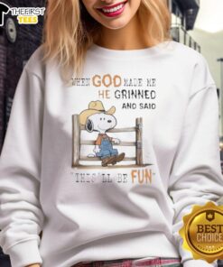 Alt Text: Official Peanuts Snoopy Cowboy sweatshirt featuring the quote When God Made Me, He Grinned and Said This'll Be Fun.