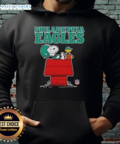 Official Philadelphia Eagles Snoopy hoodie in Peanuts style, featuring Snoopy relaxing with a football.