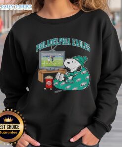 Official Philadelphia Eagles Snoopy cozy game day sweatshirt in Peanuts style, perfect for football fans.