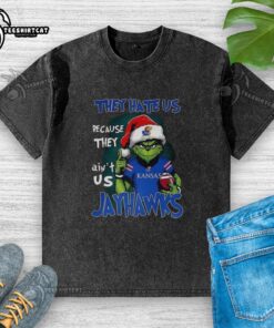 Official Santa Grinch 'They Hate Us Because They Ain't Us' Kansas Jayhawks washed t-shirt featuring colorful graphic design.