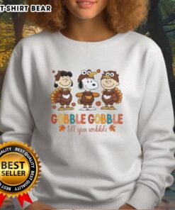 Official Snoopy and Friends Thanksgiving sweatshirt featuring a fun turkey design with 'Gobble Gobble Till You Wobble' text.