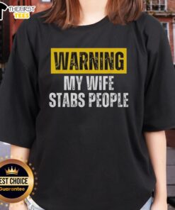 Vintage ladies tee featuring 'Official Warning: My Wife Stabs People' humorous graphic design for unique fashion statement.