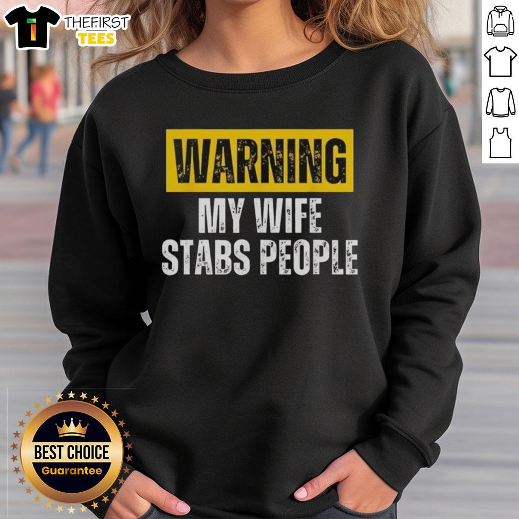 official-warning-my-wife-stabs-people-vintage-sweatshirt Alt Text: Vintage sweatshirt featuring the phrase Official Warning: My Wife Stabs People in bold letters.