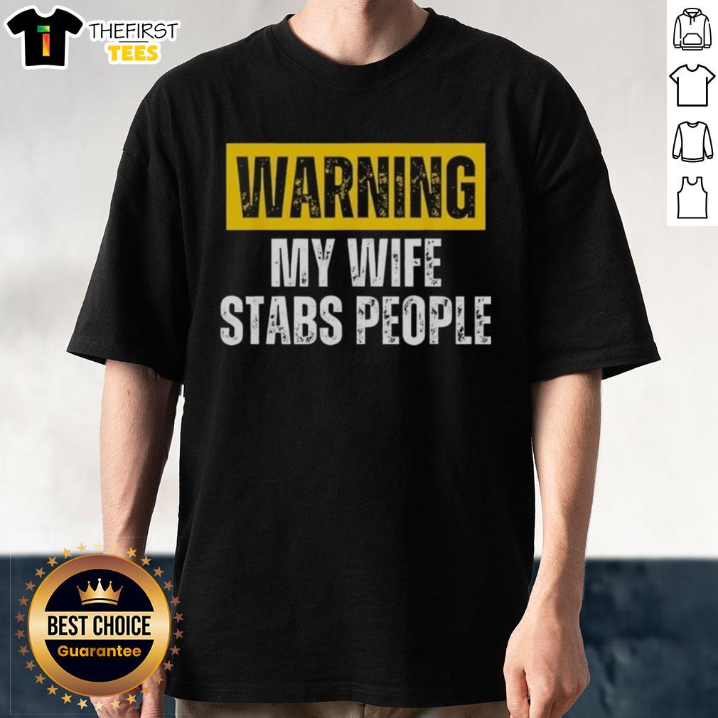 official-warning-my-wife-stabs-people-vintage-t-shirt Alt Text: Official Warning My Wife Stabs People Vintage T-Shirt design featuring humorous graphic and bold text.