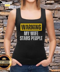 Vintage tank top featuring 'Official Warning: My Wife Stabs People' graphic, perfect for humor and unique fashion statements.