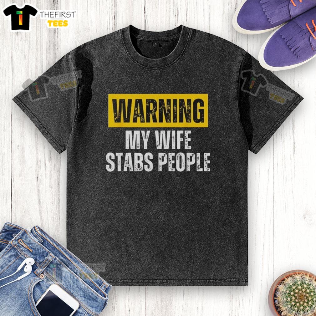 official-warning-my-wife-stabs-people-vintage-washed-t-shirt Vintage washed T-shirt featuring 'Official Warning: My Wife Stabs People' graphic, perfect for humorous apparel lovers.
