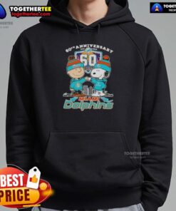 Original Charlie Brown fist bump with Snoopy on a Miami Dolphins skyline hoodie, celebrating 60th anniversary 1965-2025.