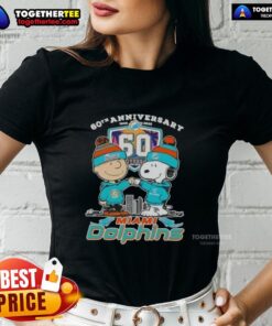 Original Charlie Brown fist bump with Snoopy, celebrating 60th Anniversary 1965-2025, featuring Miami Dolphins skyline on ladies tee.
