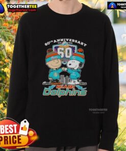 Alt Text: Original Charlie Brown fist bump with Snoopy on a Miami Dolphins skyline sweatshirt for the 60th anniversary (1965-2025).