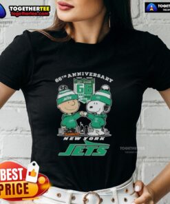 Alt Text: Original Charlie Brown fist bump with Snoopy against New York Jets skyline for 66th Anniversary ladies tee.