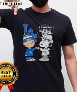 Alt Text: Original Charlie Brown fist bump with Snoopy on a Dodgers X Raiders T-Shirt, perfect for LA sports fans.