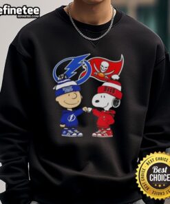 Alt Text: Original Charlie Brown fist bump with Snoopy on Tampa Bay sports sweatshirt featuring Lightning & Buccaneers logos.