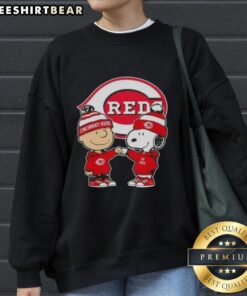 Original Charlie Brown fist bump Snoopy X Cincinnati Reds sweatshirt featuring playful design and vibrant colors.