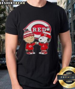 Original Charlie Brown fist bump with Snoopy graphic on Cincinnati Reds T-shirt, perfect for fans and collectors.