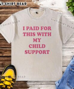 Original 'I Paid For This With My Child Support' washed t-shirt displayed on a hanger, showcasing its playful design.
