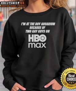 Person wearing 'Two Gay Guys on HBO Max' sweatshirt at the aquarium, showcasing pride and support for LGBTQ+ representation.