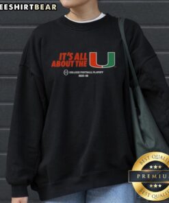 Alt Text: Original Miami Hurricanes Football 2025-26 CFP It's All About The U sweatshirt in vibrant orange and green colors.
