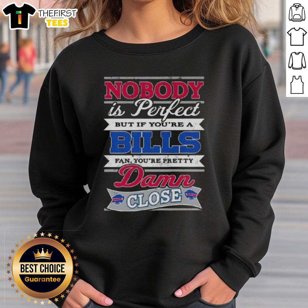 original-nobody-is-perfect-but-if-youre-a-buffalo-bills-fan-youre-pretty-damn-close-sweatshirt Alt Text: Original 'Nobody Is Perfect But If You're A Buffalo Bills Fan You're Pretty Damn Close' sweatshirt design.