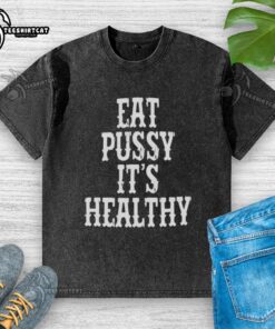 Alt Text: Original Rockstar Eat Pussy It's Healthy washed t-shirt featuring bold graphic print on a stylish design.